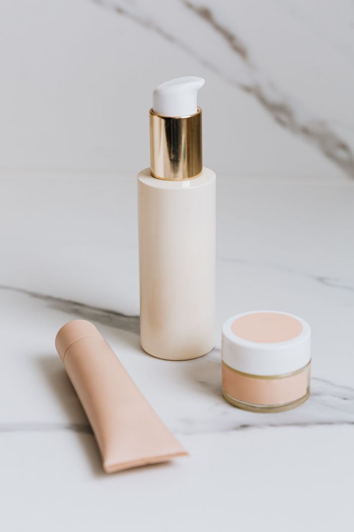 about-us-01 Luxurious skincare products elegantly arranged on a marble surface, showcasing beauty essentials.