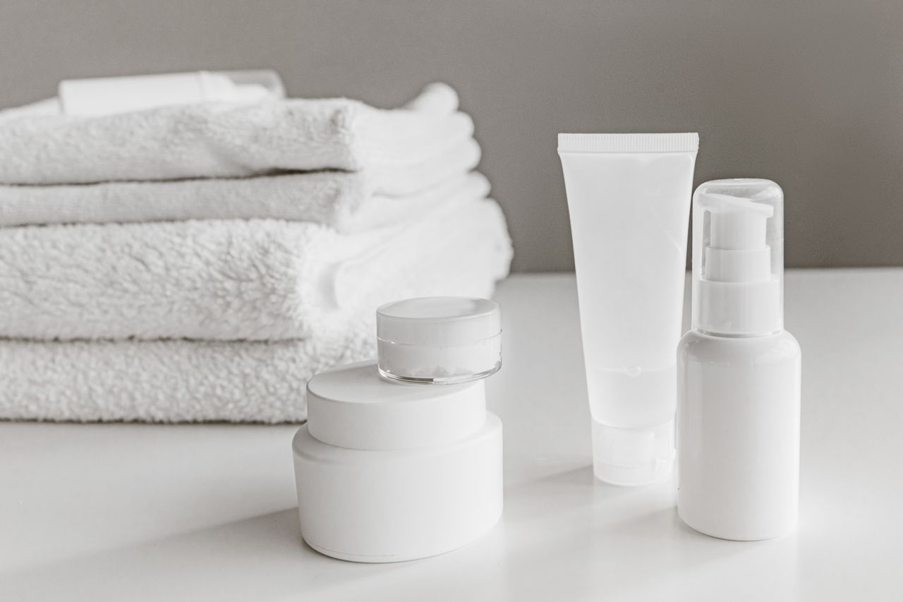 about-us-02 Minimalist arrangement of white skincare products and towels for a modern aesthetic.